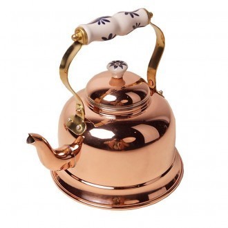 A copper teapot with a porcelain handle
